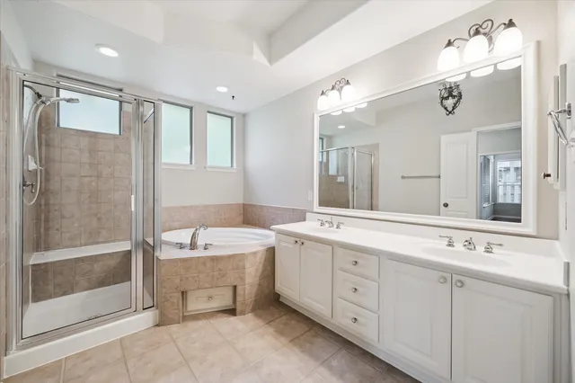 a spacious bathroom with a double vanity sink mirror and double