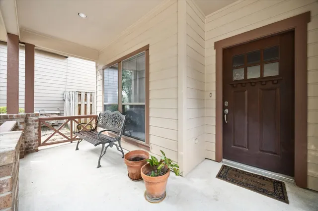 a dining room with furniture and a potted plant