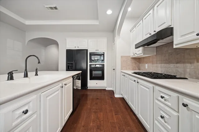 a kitchen with sink a stove and refrigerator