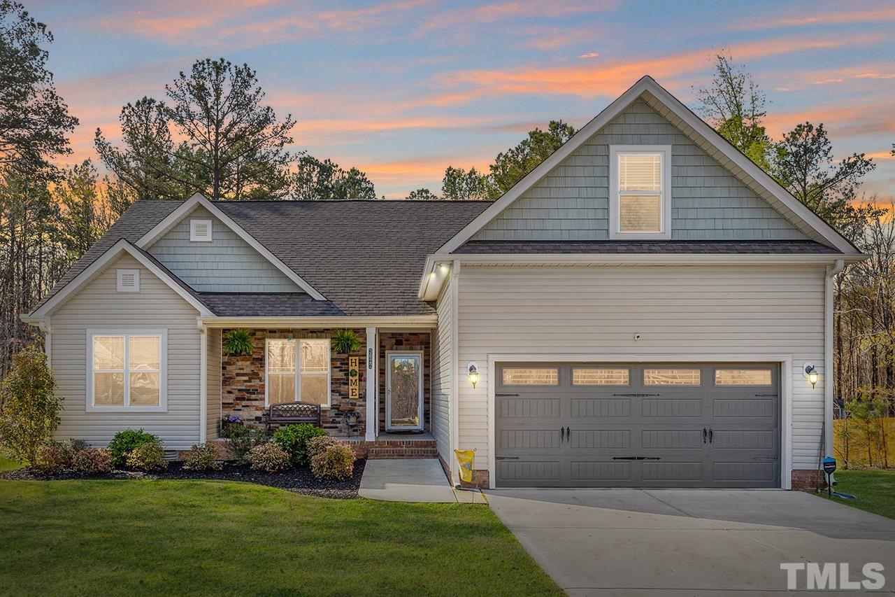 a view of a yard in front view of a house