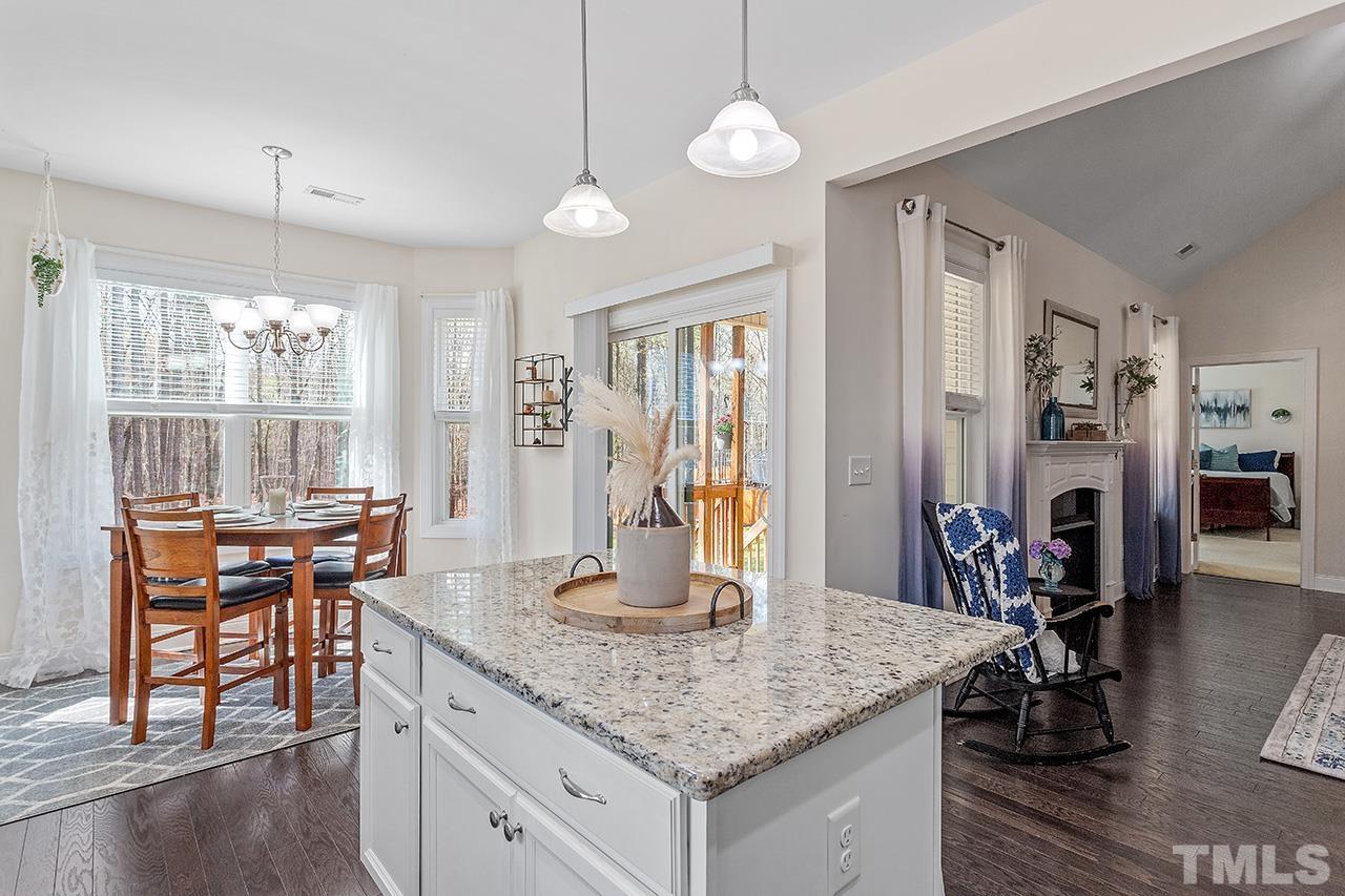 3622 Pine Needles Drive Wake Forest, NC 27587 - Photo 17 of 35 a kitchen with center island table and chairs in it