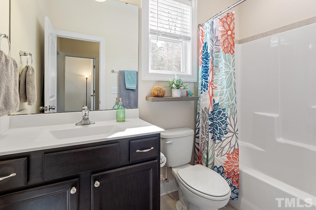 3622 Pine Needles Drive Wake Forest, NC 27587 - Photo 27 of 35 a bathroom with a sink a toilet a mirror and shower