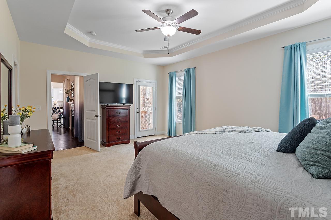 3622 Pine Needles Drive Wake Forest, NC 27587 - Photo 28 of 35 a bedroom with a bed and a chandelier