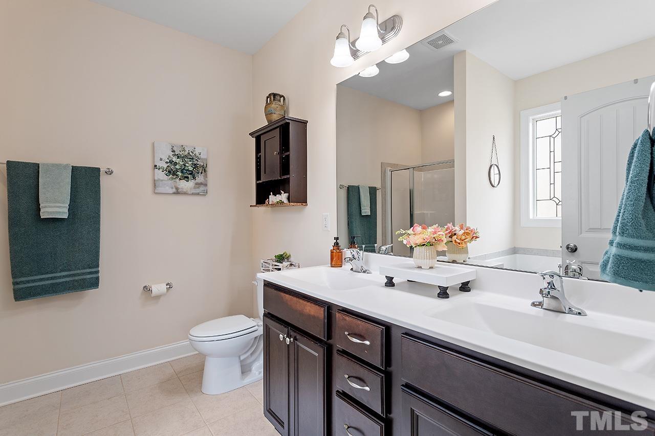 3622 Pine Needles Drive Wake Forest, NC 27587 - Photo 30 of 35 a bathroom with a double vanity sink toilet and shower