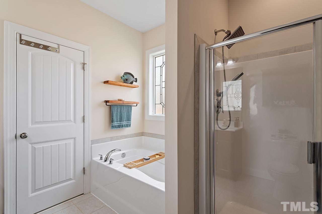 3622 Pine Needles Drive Wake Forest, NC 27587 - Photo 31 of 35 a bathroom with a tub a shower and a sink