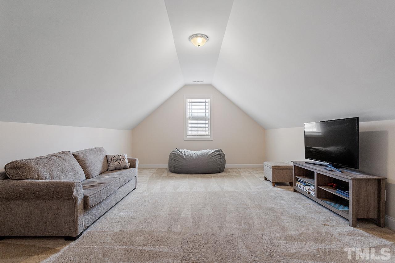 3622 Pine Needles Drive Wake Forest, NC 27587 - Photo 34 of 35 a living room with furniture and a flat screen tv