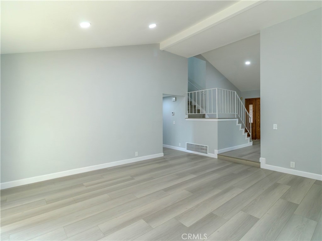 518 West Alpine Avenue Santa Ana, CA 92707 - Photo 11 of 29 an empty room with wooden floor and windows