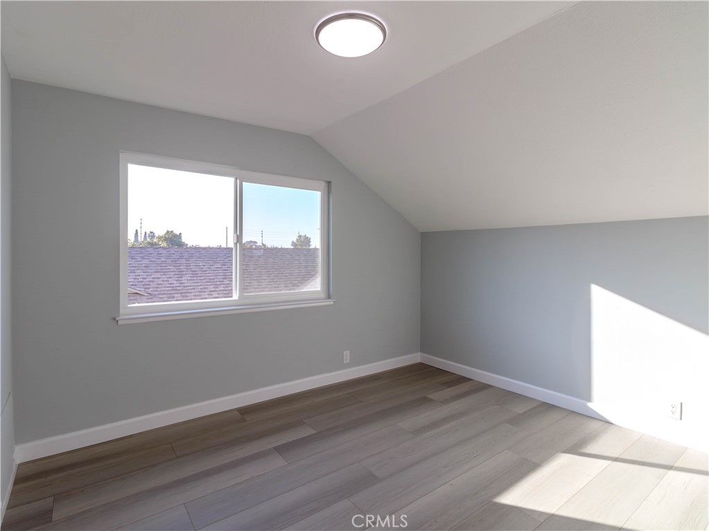 518 West Alpine Avenue Santa Ana, CA 92707 - Photo 15 of 29 an empty room with wooden floor and windows