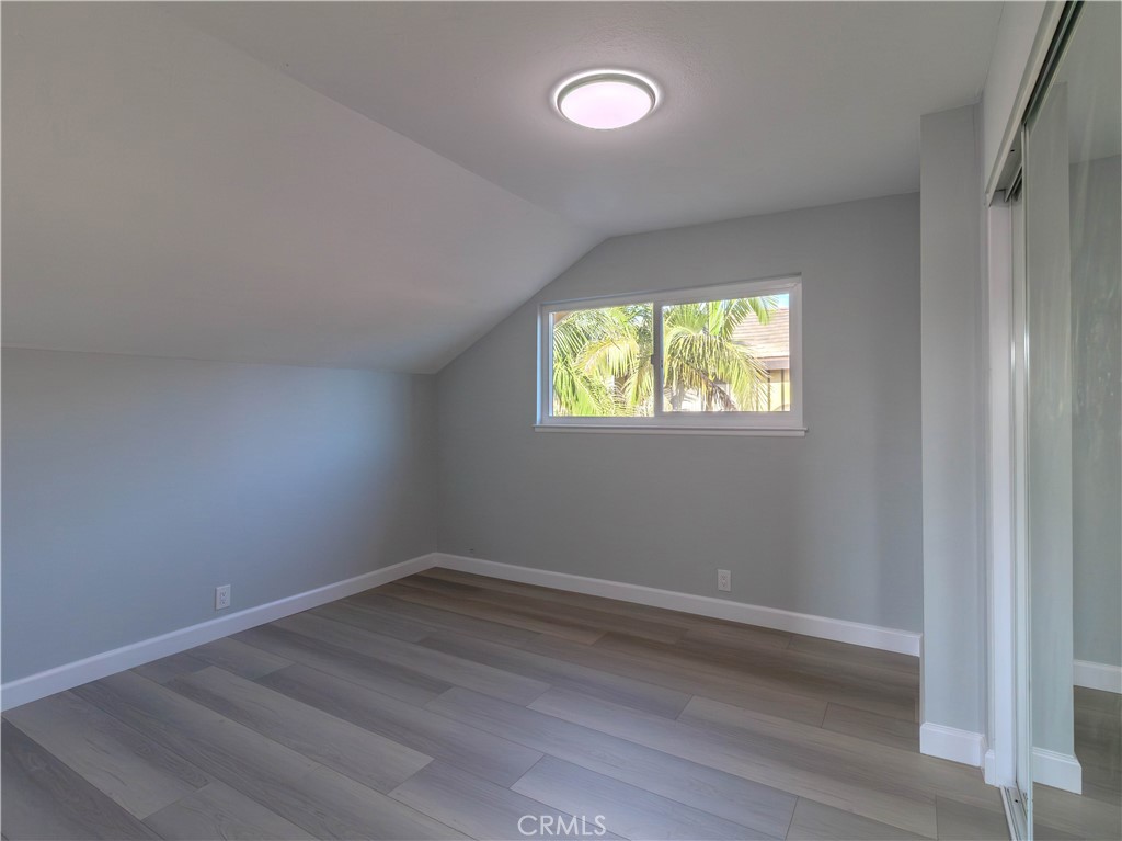 518 West Alpine Avenue Santa Ana, CA 92707 - Photo 16 of 29 an empty room with wooden floor and windows