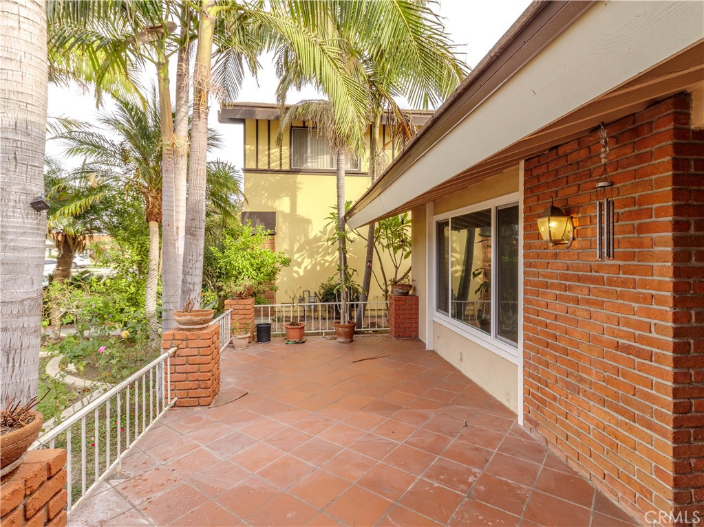 518 West Alpine Avenue Santa Ana, CA 92707 - Photo 24 of 29 a view of a patio with table and chairs and floor to ceiling window