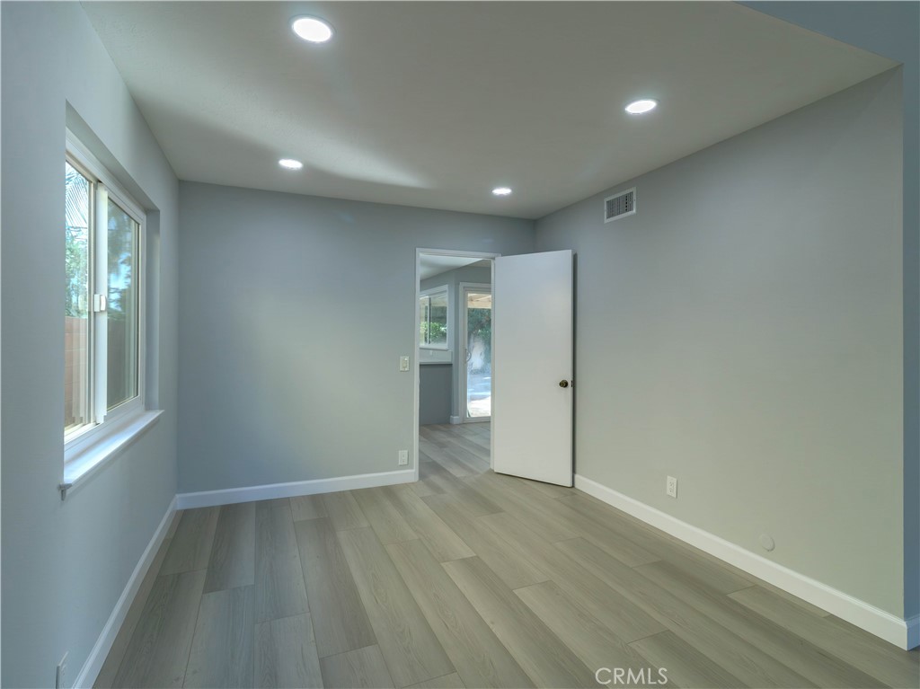 518 West Alpine Avenue Santa Ana, CA 92707 - Photo 6 of 29 an empty room with wooden floor and windows