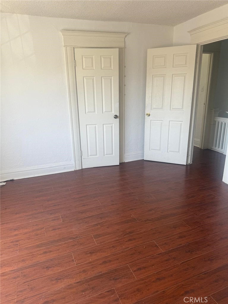 1527 North Broadway, Unit 2 Santa Ana, CA 92701 - Photo 16 of 21 a view of an empty room with wooden floor