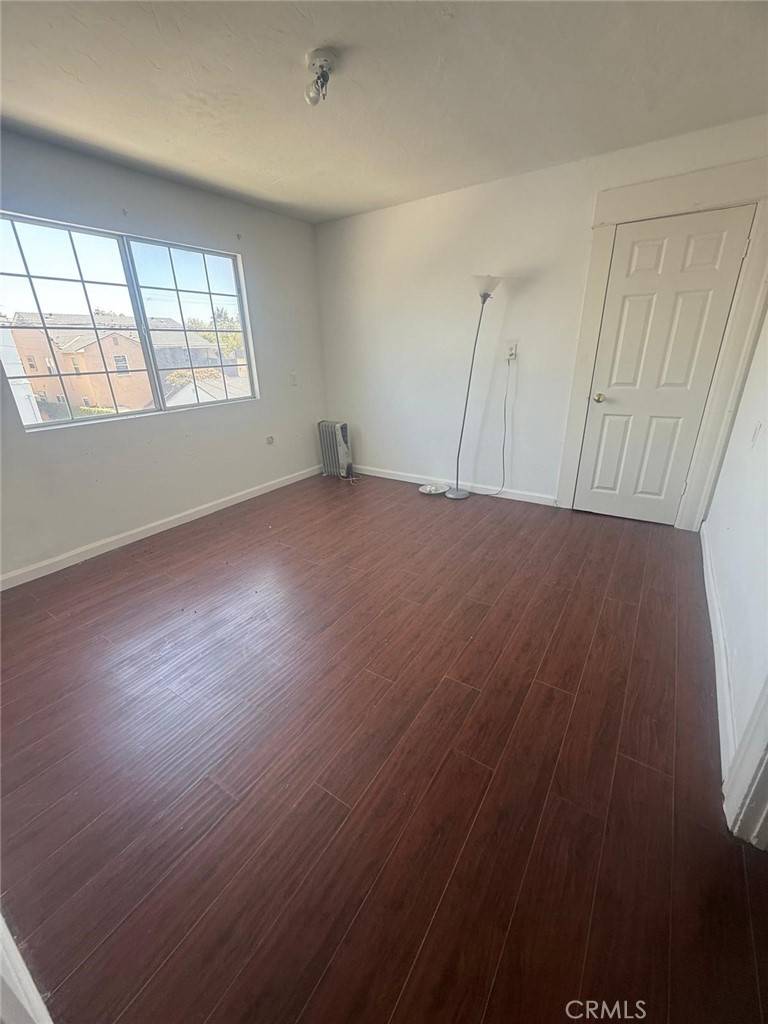 1527 North Broadway, Unit 2 Santa Ana, CA 92701 - Photo 17 of 21 an empty room with wooden floor and windows