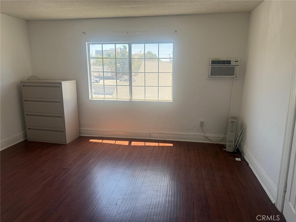 1527 North Broadway, Unit 2 Santa Ana, CA 92701 - Photo 6 of 21 an empty room with wooden floor and window