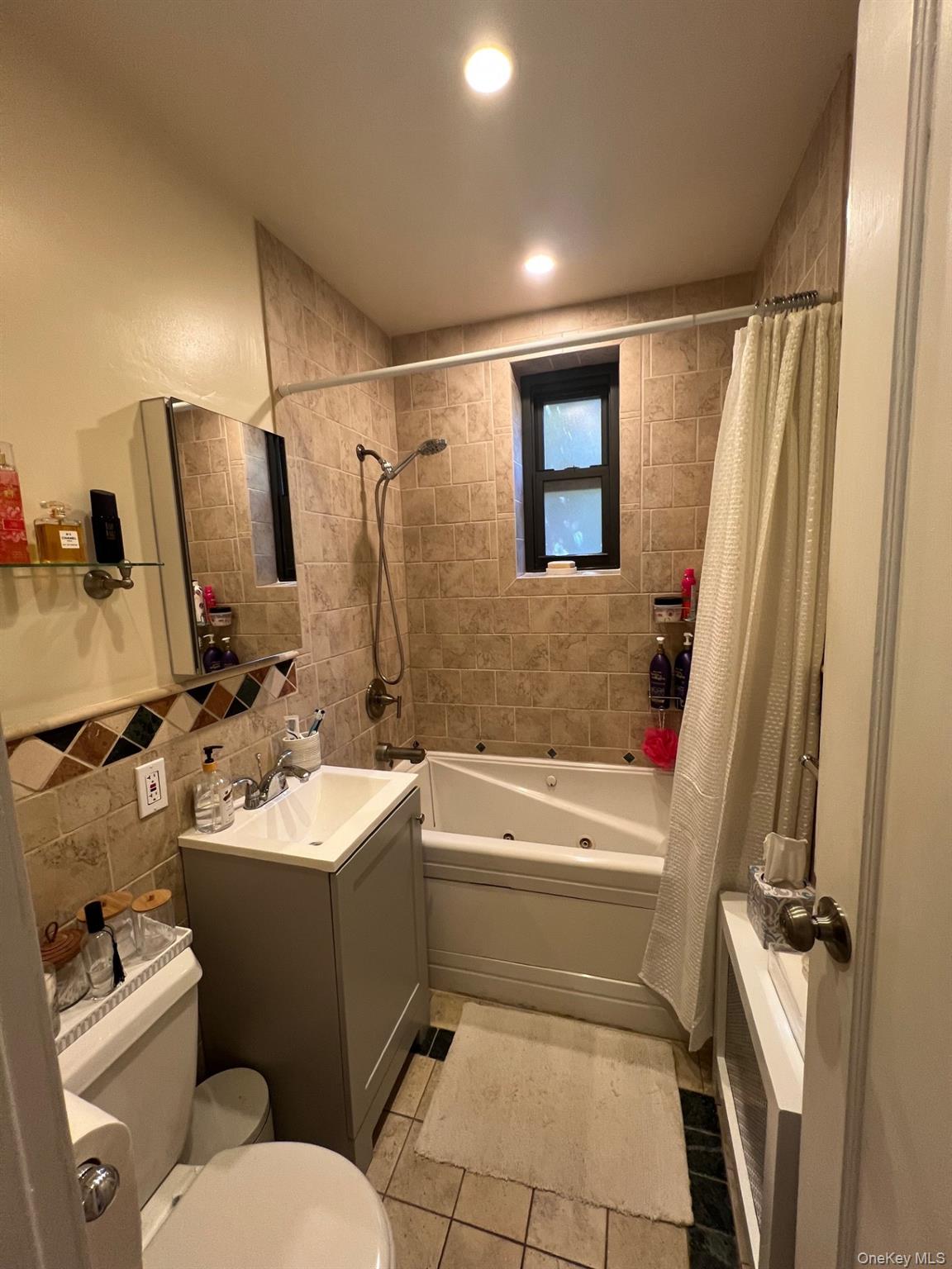 200 Richbell Road, Unit A2 Mamaroneck, NY 10543 - Photo 8 of 14 a bathroom with a toilet sink and mirror