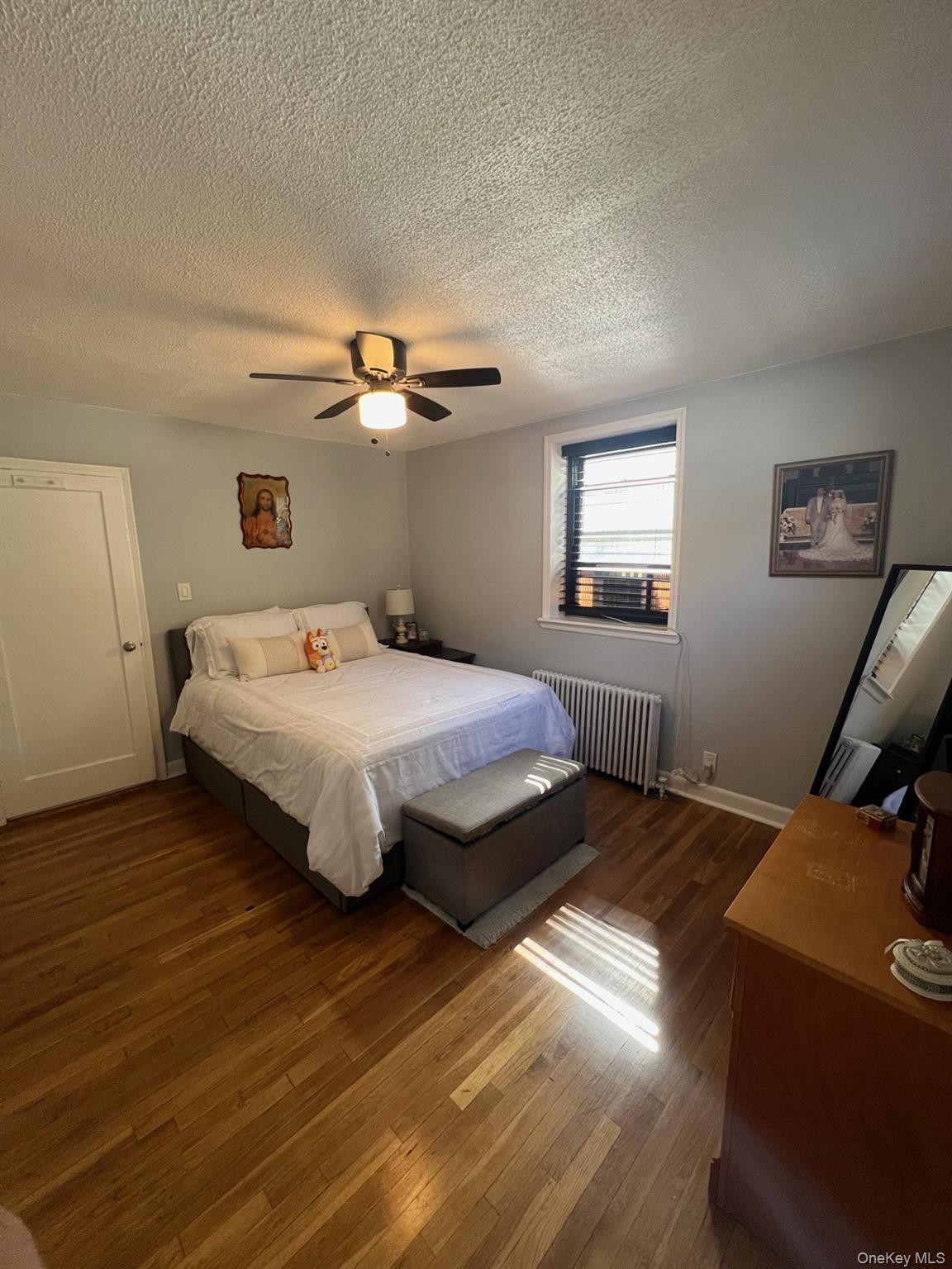200 Richbell Road, Unit A2 Mamaroneck, NY 10543 - Photo 9 of 14 a bedroom with a bed and wooden floor