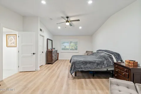a bedroom with a bed dresser and a window