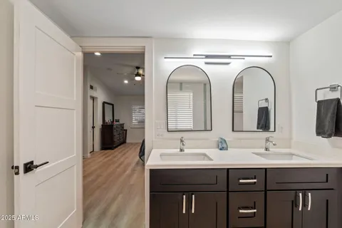 a bathroom with a double vanity sink and a mirror
