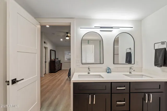 a bathroom with a double vanity sink and a mirror