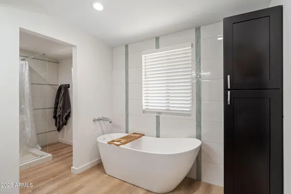 a spacious bathroom with a bathtub and next to a window