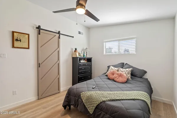 a bedroom with a bed and wooden floor