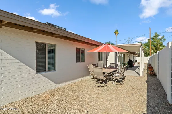 a patio with table and chairs