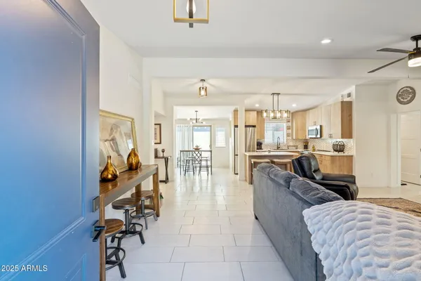 a large living room with stainless steel appliances kitchen island granite countertop lots of white stainless steel appliances