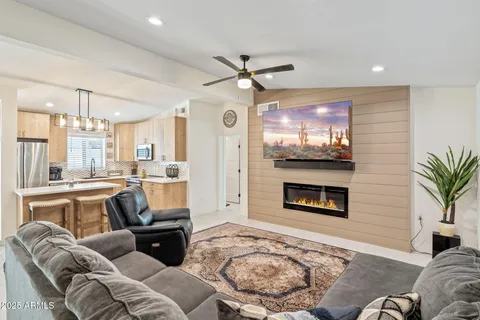 a living room with furniture a fireplace and a flat screen tv