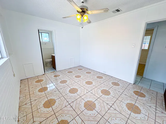 a bedroom with a bed and a mirror