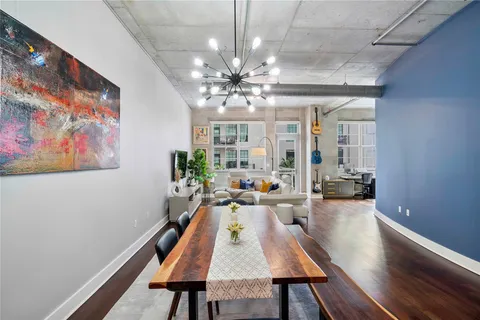 a living room with furniture a chandelier and a large window