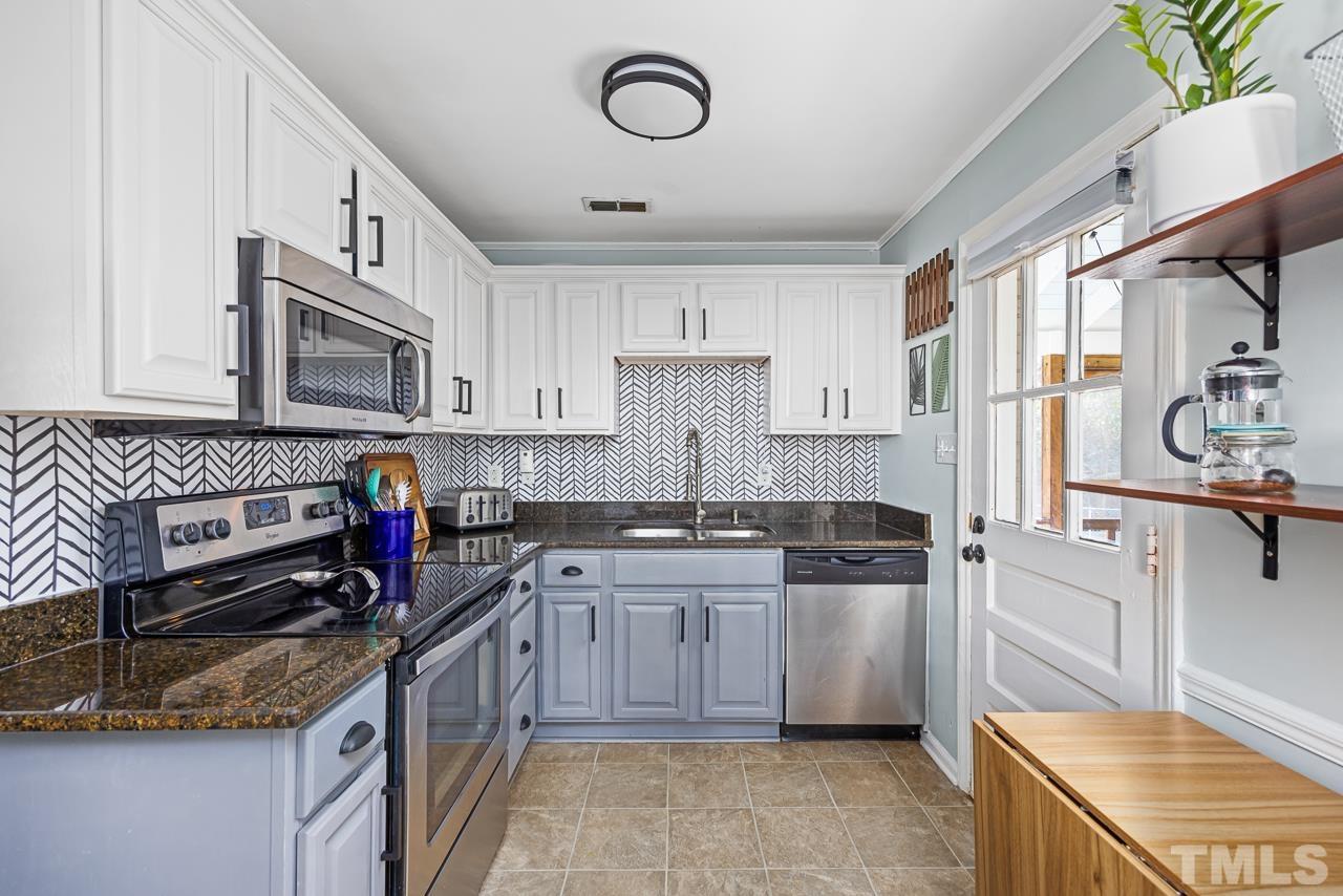 2458 Stevens Road Raleigh, NC 27610 - Photo 8 of 20 a kitchen with stainless steel appliances granite countertop a stove top oven a sink dishwasher and a refrigerator
