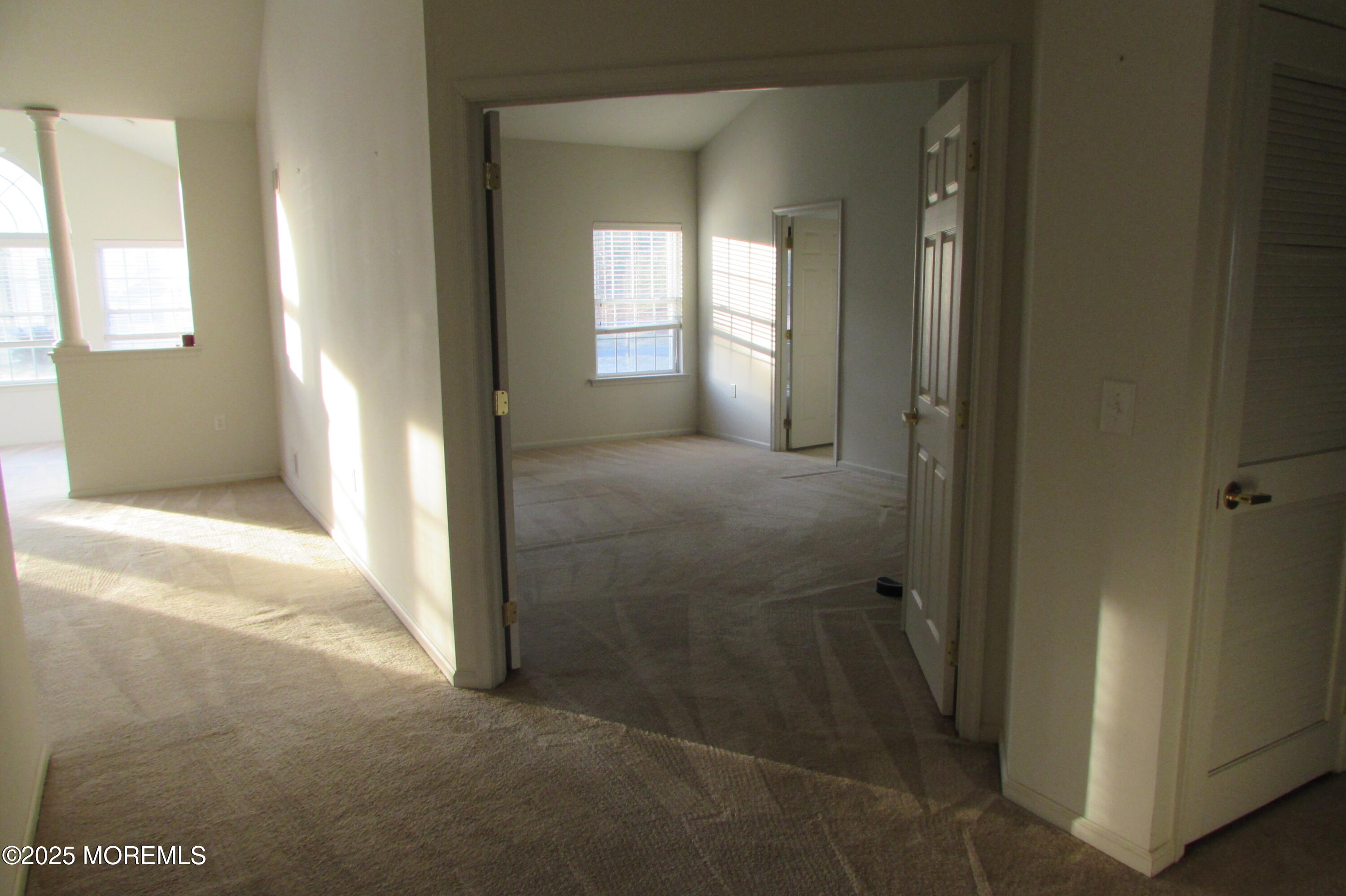 66 Strathmere Street Waretown, NJ 08758 - Photo 11 of 29 a view of a hallway with wooden floor and a livingroom