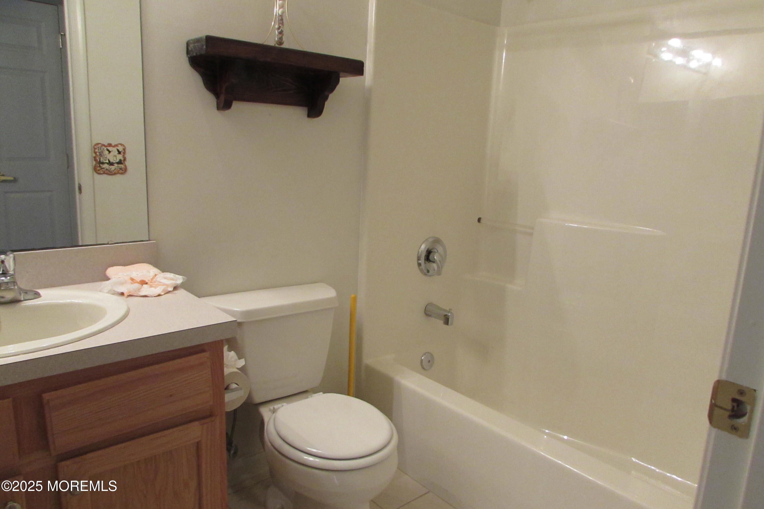 66 Strathmere Street Waretown, NJ 08758 - Photo 15 of 29 a white toilet sitting next to a bath tub