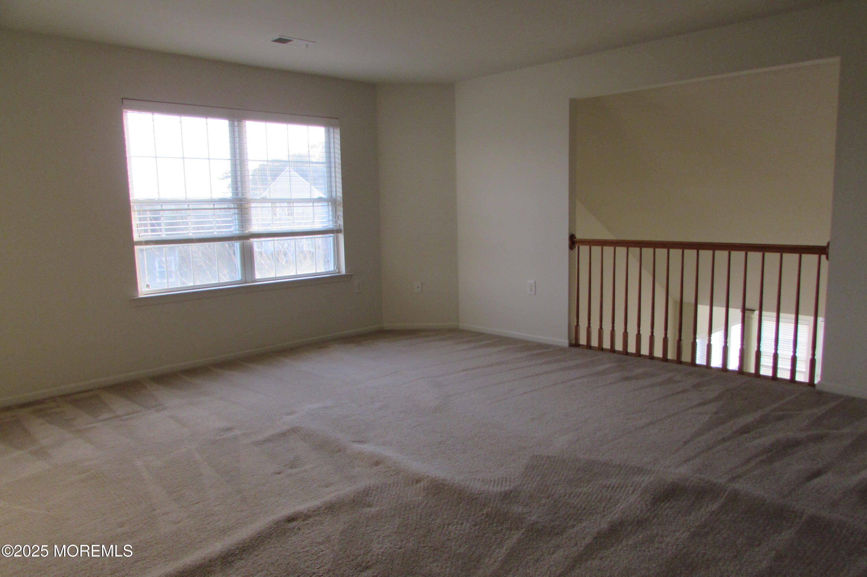 66 Strathmere Street Waretown, NJ 08758 - Photo 25 of 29 an empty room with wooden floor and windows