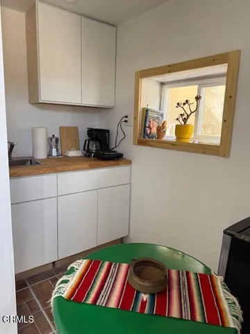 a bathroom with a sink and mirror with toilet