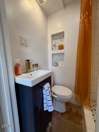 a bathroom with a sink toilet and a mirror