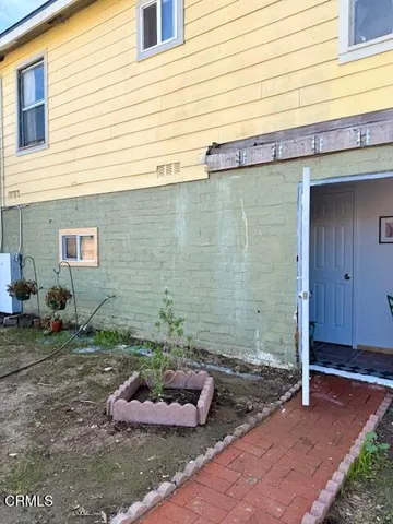 a view of a backyard with plants and entertaining space