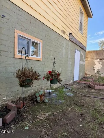a view of a chairs and table in backyard