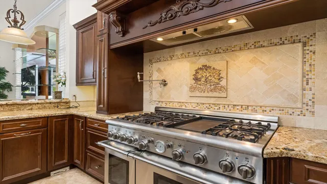 a stove top oven sitting inside of a kitchen