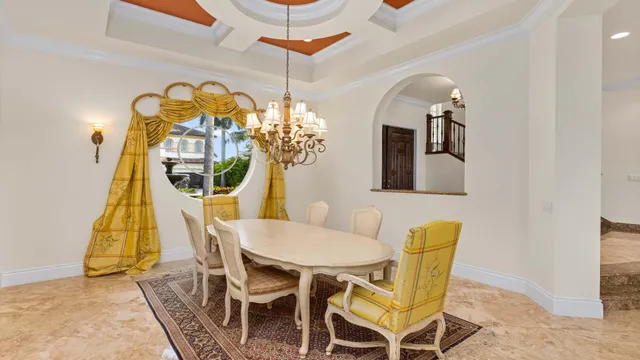 a view of a dining room with furniture and chandelier