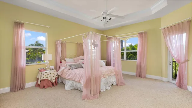 a bedroom with a large bed and a chandelier