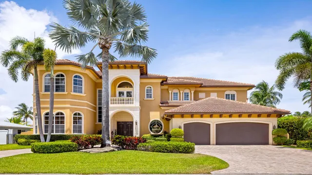 a front view of a house with a garden and plants