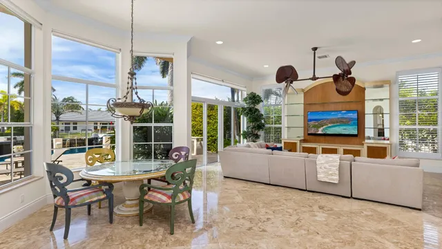 a living room with furniture a flat screen tv and a large window