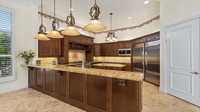 a kitchen with stainless steel appliances granite countertop a sink and cabinets