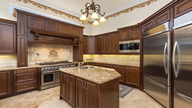 a kitchen with a stove sink and refrigerator