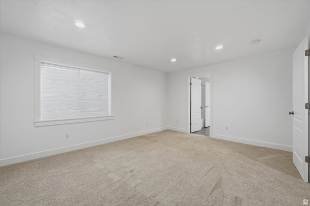 791 East Saddle Road Grantsville, UT 84029 - Photo 35 of 46 Spacious room featuring neutral carpeting, white walls, recessed ceiling lighting, a large window with blinds, and white trim