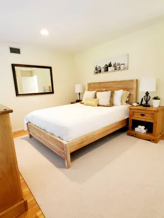 a bedroom with a bed and lamp