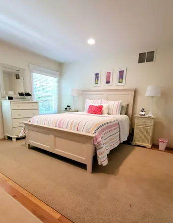 a bedroom with a bed and a couch