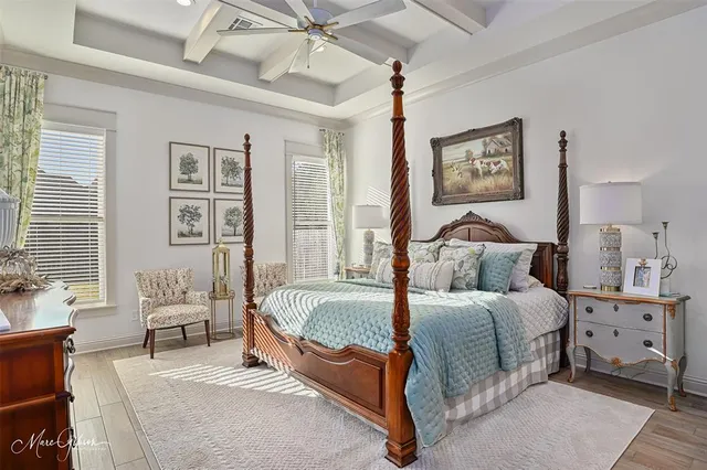 a bedroom with a large bed and a chandelier