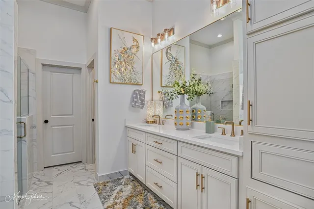 a bathroom with a granite countertop sink a mirror a vanity and a shower
